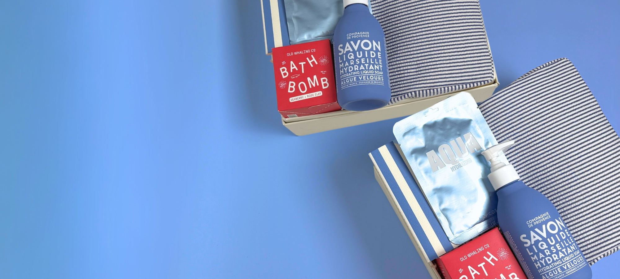 Bath products including a bath bomb and soap bars on a blue background